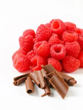 Heaps of fresh raspberries and chocolate curls Stock Photos
