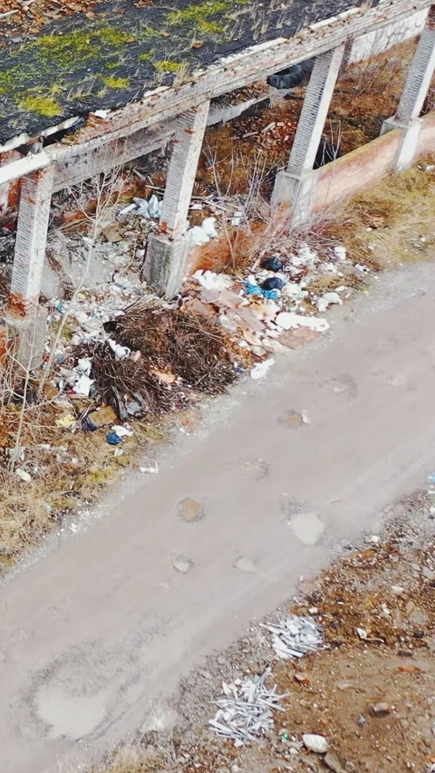 Heaps of garbage, destroyed industrial buildings with collapsed roofs. Stock Footage 272298649