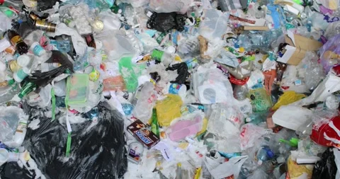 Heaps of miscellaneous unsorted waste, plastic, cellophane, paper. Stock Footage 155991392