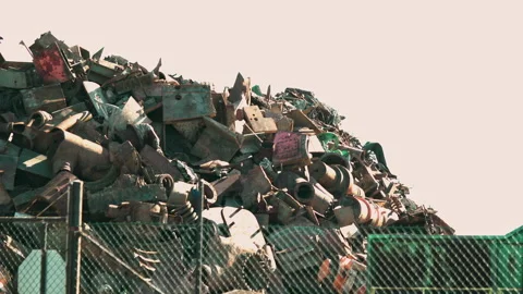 Heaps of rusty hot scrap metal at landfill site. Heat haze visible. Stock Footage 157157806