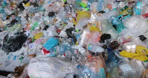 Heaps of various waste, plastic lids, cellophane bags, paper. Stock Footage 156045082