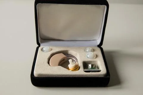 Hearing aid in black case on table Stock Photos