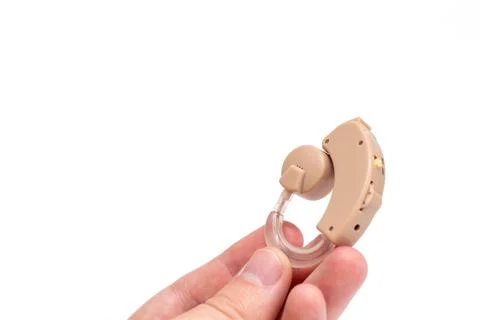 Hearing aid device on hand Stock Photos