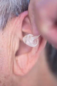 Hearing aid in ear Stock Photos
