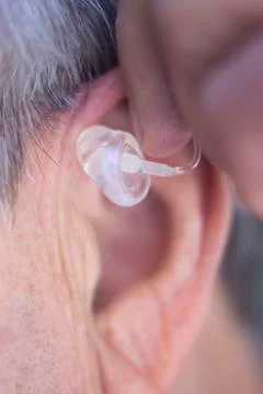 Hearing aid in ear Stock Photos