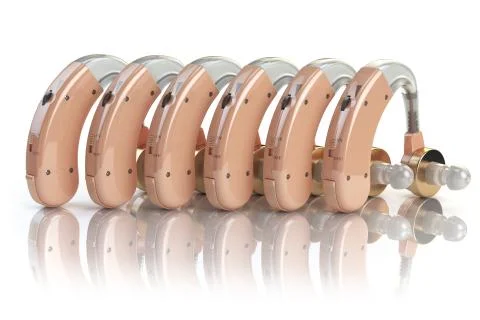 Hearing aids in a row isolated on white background. Deaf ear aid. Stock Photos