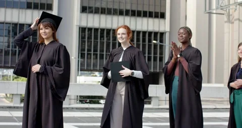 Hearing applause, Diverse graduates fixing caps and clapping to mark graduation Stock Footage 344383103