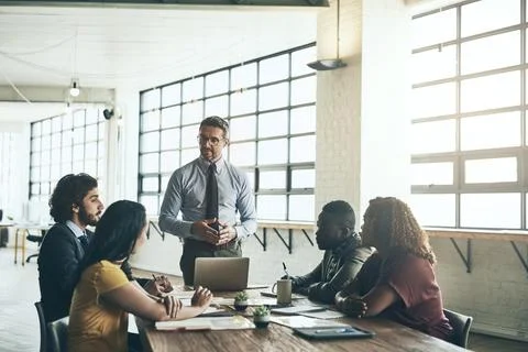 Hearing every idea objectively. a well-dressed businessman presenting a new idea Stock Photos