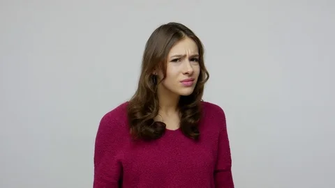 Hearing problems, deafness. Nice-looking brunette woman in pullover holding hand Video stock 124291885