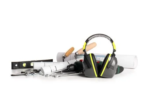 Hearing protectors with set of construction tools and house plans isolated on Stock Photos