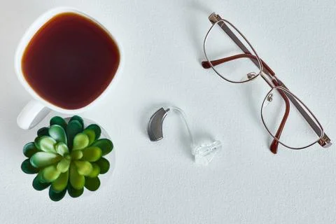 Hearing solutions, concept. From above, a hearing assistance device sits be.. Stock Photos