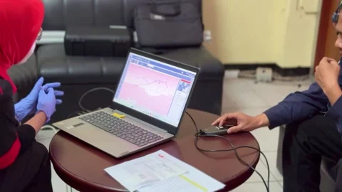 Hearing test procedure with audiometer and laptop. Stock Footage 336652907
