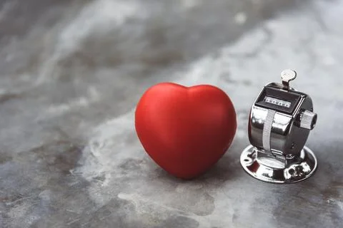 Heart and countdown counter on marble table surface. Medical and health car.. Stock Photos