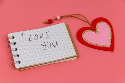 Heart and notepad with handwritten text " I Love You" Stock Photos