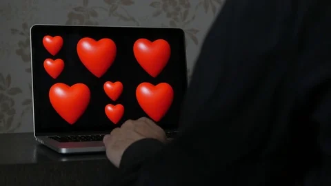 Heart animation loop on laptop, man watching Stock-Footage 76697290