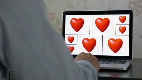 Heart animation loop on laptop screen, man watching Vídeos de archivo 76554939