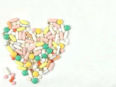 Heart of assorted colored pills. Stock Photos