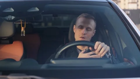 Heart attack in a car driver while driving Stock Footage 321311903