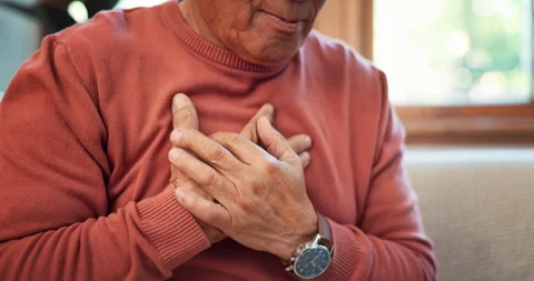 Heart attack, hands and senior man on sofa with lungs, problem or breathe, risk Stock Footage 254825791