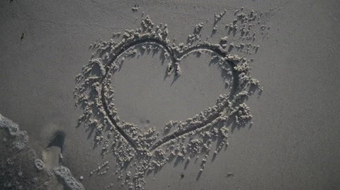 Heart Being Washed Away On Sandy Beach Stock Footage 64066281
