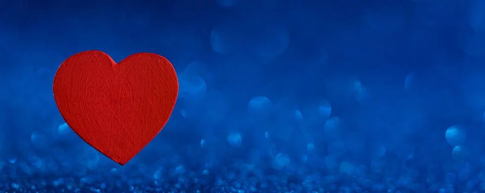 Heart in blue background Stock Photos