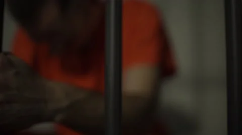 A heart broken inmate in prison grips bars Video stock 59762464