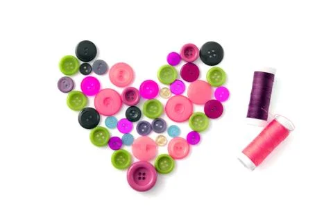 Heart of clothes buttons with sewing thread Stock Photos