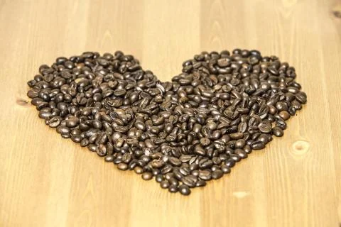 Heart from coffe beans on the table Stock Photos