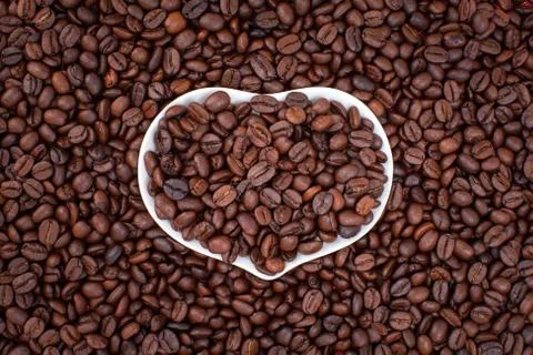 Heart on coffee beans background Stock Photos