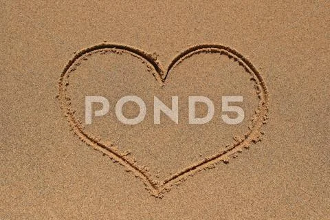 Heart drawing in sand Stock Photos
