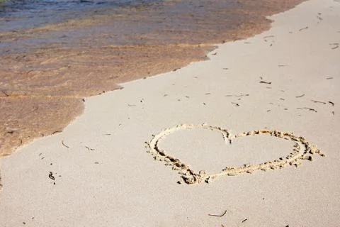 Heart drawn on the beach Stock Photos