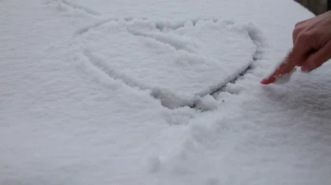 Heart drawn on a car window covered with snow Stock Footage 44496581