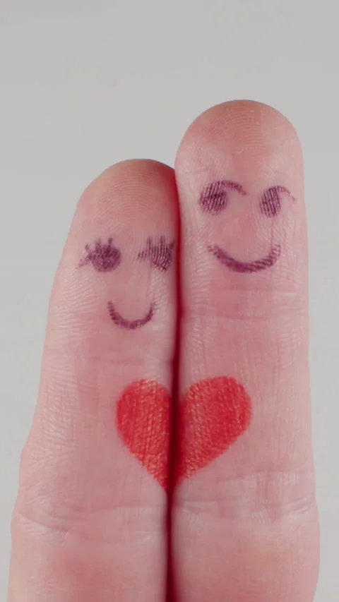 A heart is drawn on the fingers with faces Vídeo Stock 237705387