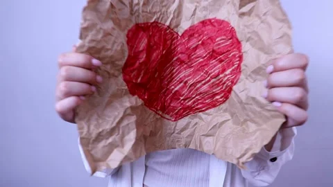Heart drawn with a red felt-tip pen on a crumpled sheet of craft paper Stock Footage 202069395