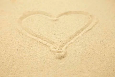 Heart drawn in the sand. Beach background. Top view Stock-Fotos
