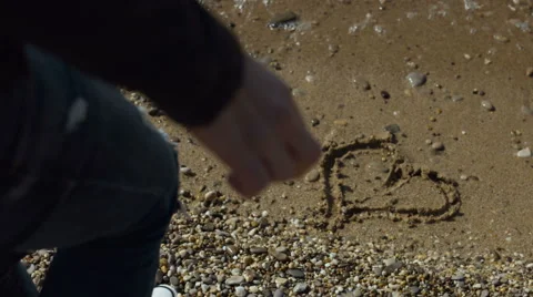 Heart drawn on the sand on the beach Video stock 62863062