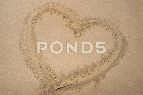 Heart drawn on sand. Horizontal composition. Stock Photos
