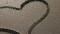 Heart drawn in the sand (pan) HD Footage