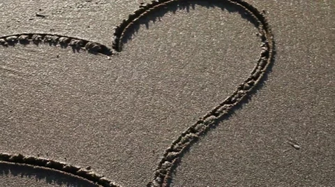 Heart drawn in the sand (pan) Stock Footage