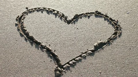 Heart drawn in the sand (pan) Stock Footage 10704834