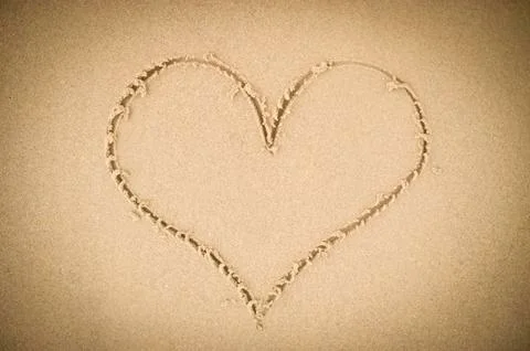 Heart drawn in the sand Stock Photos