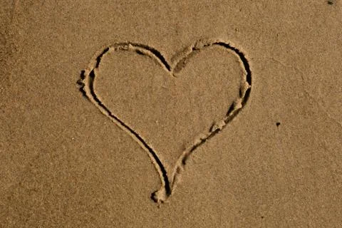 Heart drawn in sand Stock Photos