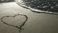 Heart drawn in the sand (with wave) HD Footage