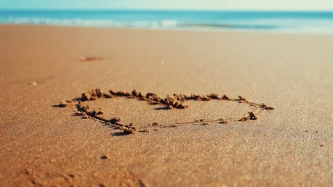 The heart is drawn on the shore of the ocean Video stock 85446271