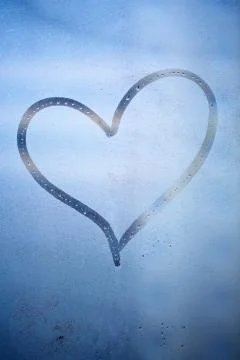 Heart drawn on a wet window Stock Photos