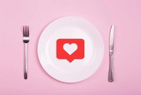 Heart on an empty plate on a pink background. Minimal art creative concept. R Stock Photos