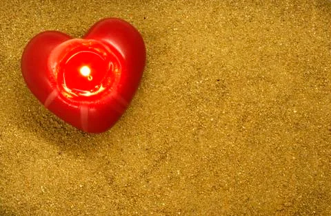 Heart with fire on sand Foto stock
