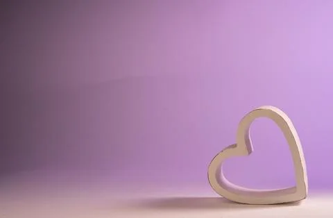 Heart frame resting on its side on a gradient background from white to lilac Stock Photos