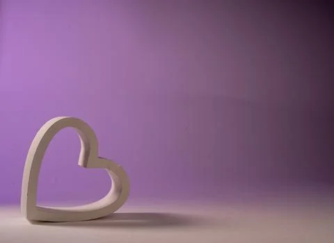 Heart frame resting on its side on a gradient background from white to lilac Stock Photos