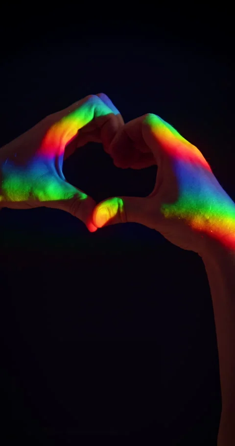 Heart Gesture with Two Hands in Rainbow Light on Black Background Stock Footage 347832817